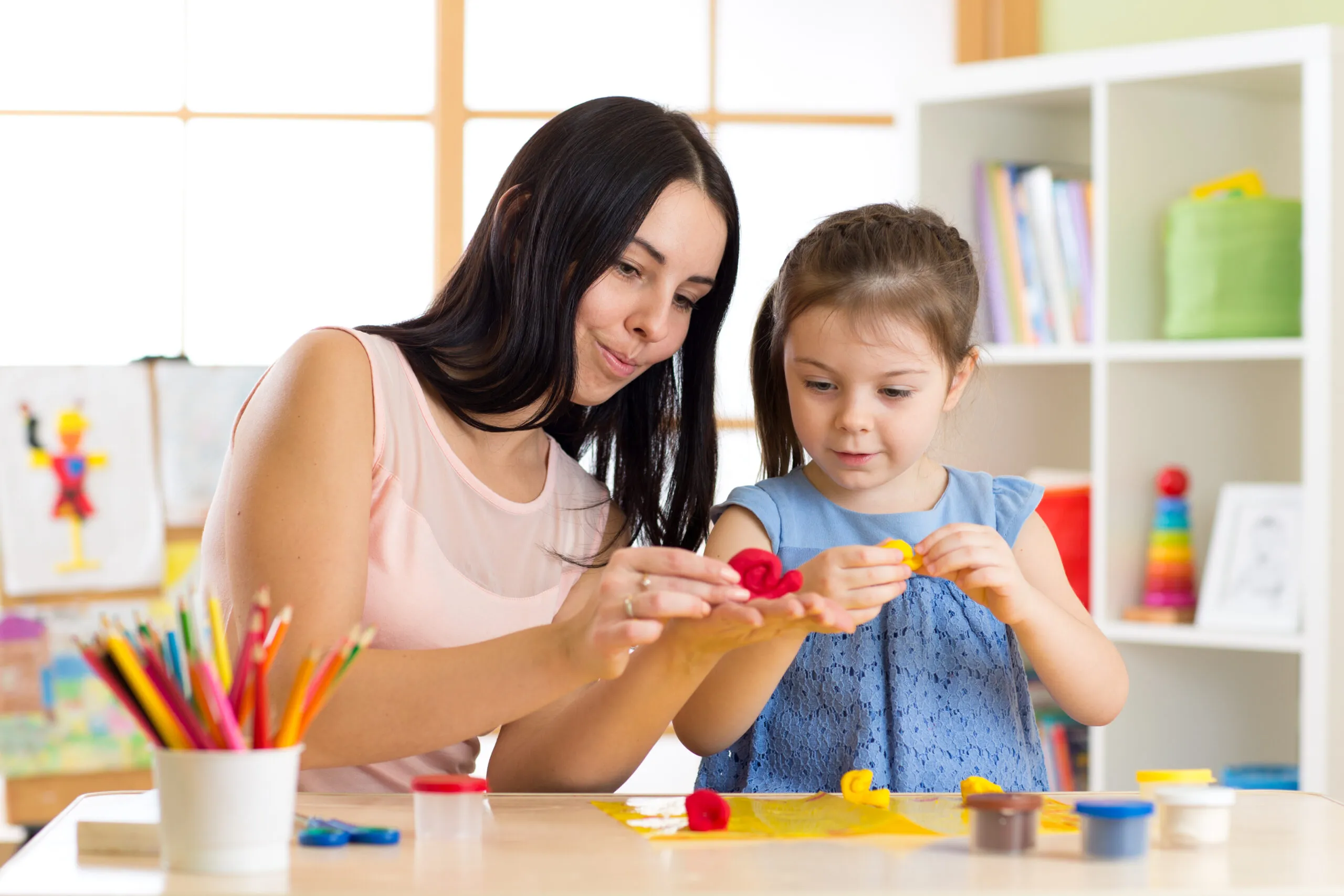 Mother and daughter playing clay together